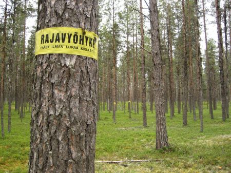 Finnish border zone sign on a tree